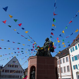 Blick auf einen Brunnen mit Fasnets-Dekoration