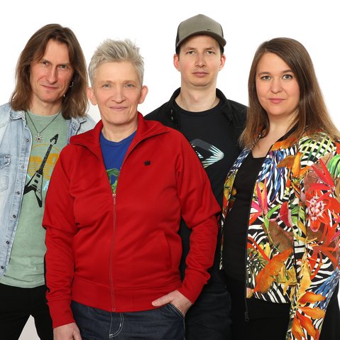 Bild von Suli Puschban und den drei Bandmitgliedern vor einem weißen Hintergrund.