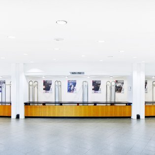 Innenansicht auf die Garderobe. Die Wände sind in hellen Tönen gehalten, der Bereich verfügt über einen Parkettboden. 