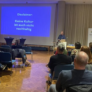 Der Vortrag von Impulsgeber Jacob Sylvester Bilabel thematisiert die Bedeutung nachhaltiger Kultur mit einer Präsentation.