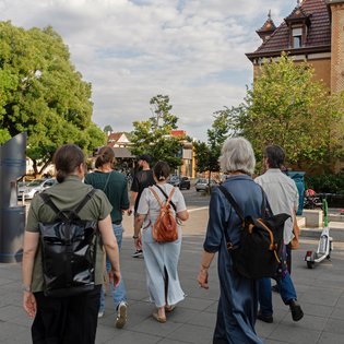eine Gruppe von Workshopteilnehmern läuft durch die Straße in Zuffenhausen